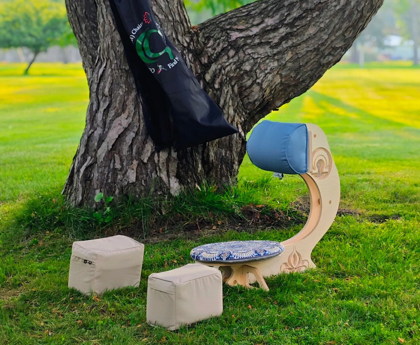 Close-up of the OM Chair seat cushion and sculpted wooden base with decorative carved detail
