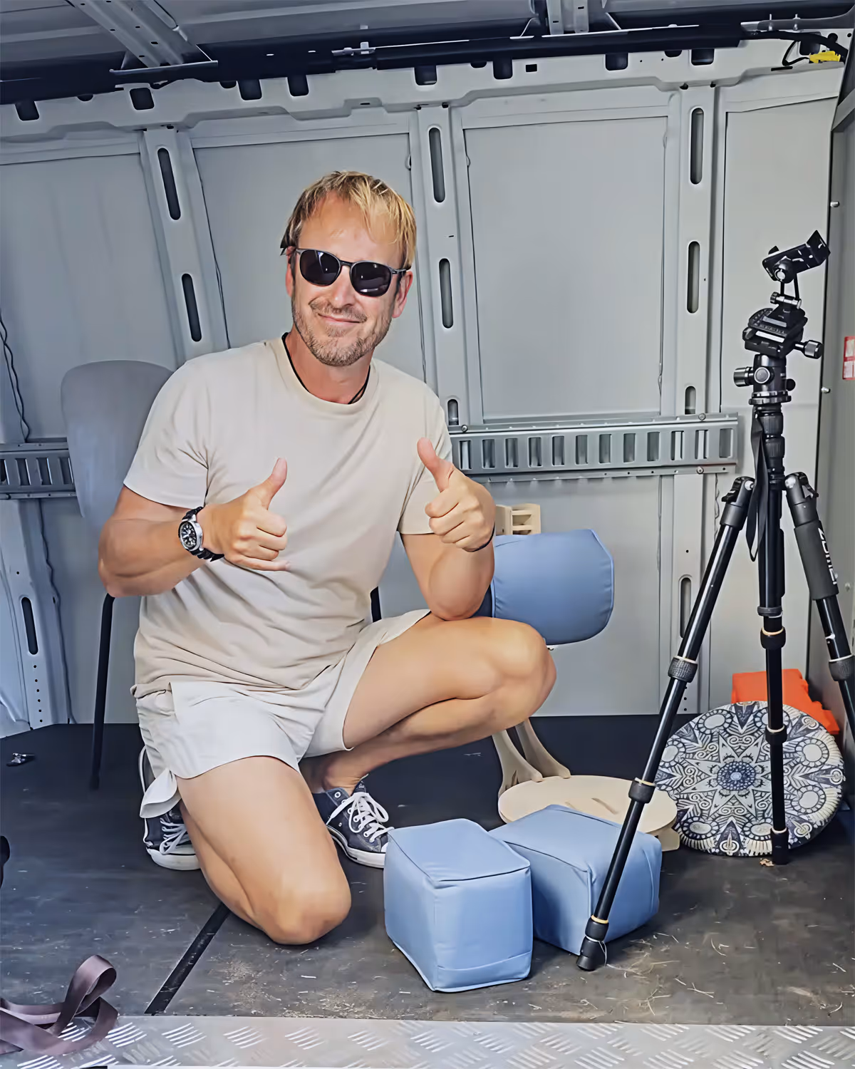 Scott Marecek, Executive Director of OM Foundation, seated outdoors with the OM Chair, smiling with thumbs up